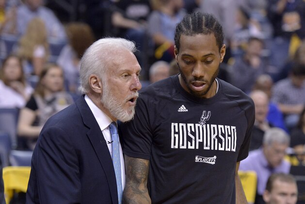 San Antonio Spurs head coach Gregg Popovich, left, talks with San Antonio Spurs forward Kawhi Leonard during the second half of Game 4 in an NBA basketball first-round playoff series against the Memphis Grizzlies Saturday, April 22, 2017, in Memphis, Tenn. (AP Photo/Brandon Dill)