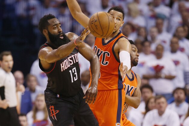Houston Rockets guard James Harden (13) passes in front of Oklahoma City Thunder forward Andre Roberson, right, in the third quarter of Game 4 of a first-round NBA basketball playoff series in Oklahoma City, Sunday, April 23, 2017. Houston won 113-109. (AP Photo/Sue Ogrocki)