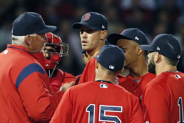 Boston Red Sox's Carl Willis, left, talks with Rick Porcello, center, on the mound during the third inning of a baseball game against the Tampa Bay Rays in Boston, Friday, April 14, 2017. (AP Photo/Michael Dwyer)