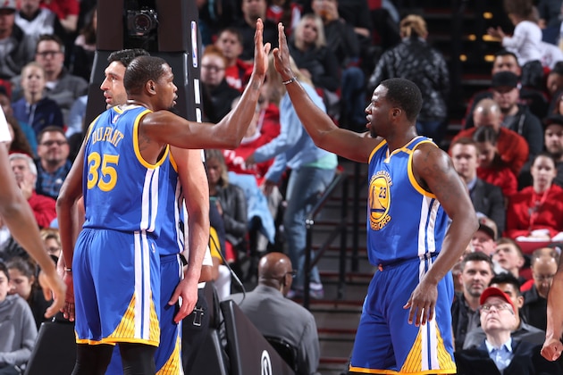 PORTLAND, OR - APRIL 24:  Kevin Durant #35 and Draymond Green #23 of the Golden State Warriors high five during the game against the Portland Trail Blazers during Game Four of the Western Conference Quarterfinals of the 2017 NBA Playoffs on April 24, 2017 at the Moda Center in Portland, Oregon. NOTE TO USER: User expressly acknowledges and agrees that, by downloading and or using this Photograph, user is consenting to the terms and conditions of the Getty Images License Agreement. Mandatory Copyright Notice: Copyright 2017 NBAE (Photo by Sam Forencich/NBAE via Getty Images)