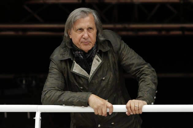 FILE - In this Monday, May 23, 2016 file picture, former Romanian tennis ace Ilie Nastase watches a match of the French Open tennis tournament at the Roland Garros stadium, in Paris, France. Ilie Nastase has received Romania's highest award, the Star of Romania, on his 70th birthday from President Klaus Iohannis for services to sport in Bucharest, Romania, Tuesday, July 19, 2016. (AP Photo/Alastair Grant, File)
