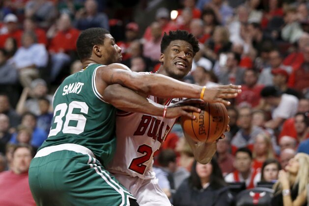 Chicago Bulls' Jimmy Butler (21) is pressured by Boston Celtics' Marcus Smart during the second half in Game 4 of an NBA basketball first-round playoff series in Chicago, Sunday, April 23, 2017. The Celtics won 104-95. (AP Photo/Charles Rex Arbogast)