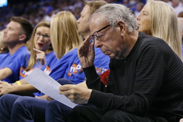 Leslie Alexander, owner of the Houston Rockets, looks over a stat sheet during the third quarter of the team's first-round NBA basketball playoff game against the Oklahoma City Thunder in Oklahoma City, Friday, April 21, 2017. Oklahoma City won 115-113. (AP Photo/Sue Ogrocki)