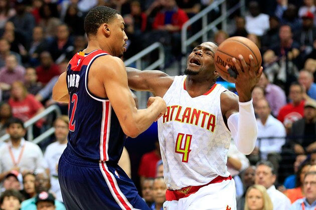 ATLANTA, GA - APRIL 24: Paul Millsap #4 of the Atlanta Hawks is fouled by Otto Porter Jr. #22 of the Washington Wizards during the fourth quarter in Game Four of the Eastern Conference Quarterfinals during the 2017 NBA Playoffs at Philips Arena on April 24, 2017 in Atlanta, Georgia. NOTE TO USER: User expressly acknowledges and agrees that, by downloading and or using the photograph, User is consenting to the terms and conditions of the Getty Images License Agreement. (Photo by Daniel Shirey/Getty Images)