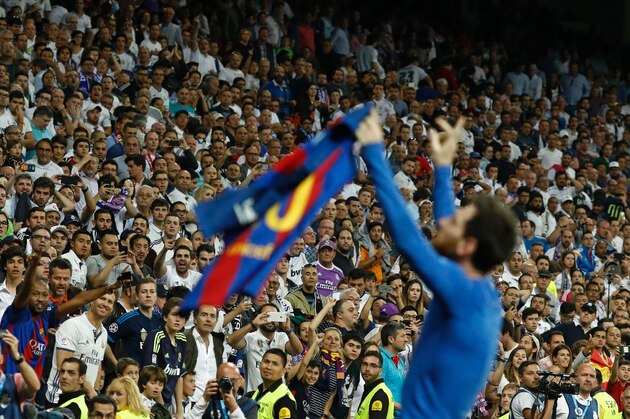 Barcelona's Argentinian forward Lionel Messi celebrates after scoring during the Spanish league Clasico football match Real Madrid CF vs FC Barcelona at the Santiago Bernabeu stadium in Madrid on April 23, 2017. / AFP PHOTO / OSCAR DEL POZO        (Photo credit should read OSCAR DEL POZO/AFP/Getty Images)