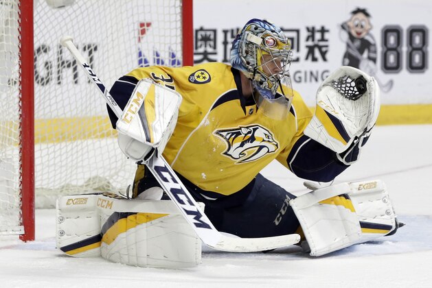 FILE- In this April 20, 2017, file photo, Nashville Predators goalie Pekka Rinne, of Finland, gloves a Chicago Blackhawks shot during the third period in Game 4 of a first-round NHL hockey playoff series in Nashville, Tenn. The St. Louis Blues will face the Predators in semifinal round of the NHL hockey play off series. (AP Photo/Mark Humphrey, File)