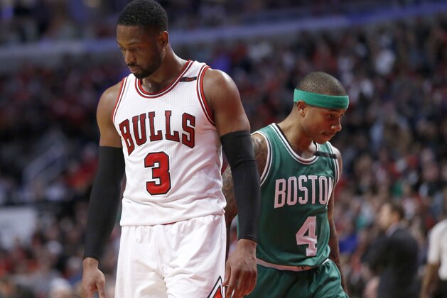 Chicago Bulls' Dwyane Wade (3) and Boston Celtics' Isaiah Thomas pass each other during the second half in Game 4 of an NBA basketball first-round playoff series in Chicago, Sunday, April 23, 2017. The Celtics won 104-95. (AP Photo/Charles Rex Arbogast)