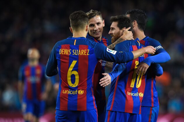 Barcelona's Argentinian forward Lionel Messi celebrates with teammates after scoring a goal during the Spanish league football match FC Barcelona vs CA Osasuna at the Camp Nou stadium in Barcelona on April 26, 2017. / AFP PHOTO / LLUIS GENE        (Photo credit should read LLUIS GENE/AFP/Getty Images)