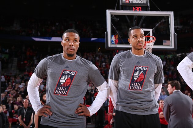 PORTLAND, OR - NOVEMBER 8:  Damian Lillard #0 and C.J. McCollum #3 of the Portland Trail Blazers stand for the National Anthem before a game against the Phoenix Suns on November 8, 2016 at the Moda Center Arena in Portland, Oregon. NOTE TO USER: User expressly acknowledges and agrees that, by downloading and or using this photograph, user is consenting to the terms and conditions of the Getty Images License Agreement. Mandatory Copyright Notice: Copyright 2016 NBAE (Photo by Sam Forencich/NBAE via Getty Images)