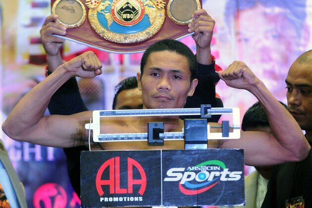 World Boxing Organisation light-flyweight champion Donnie Nietes of the Philippines flexes his muscles at the official weigh-in on June 1, 2012 in Manila.  Nietes will stake his title against Mexican challenger Felipe Salguero on June 2.   AFP PHOTO / Jay DIRECTO        (Photo credit should read JAY DIRECTO/AFP/GettyImages)