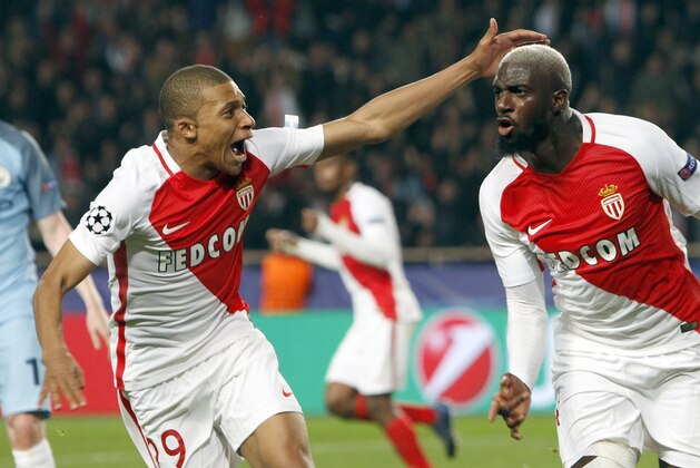 Monaco's Tiemoue Bakayoko, right, celebrates his side side's 3rd goal with Kylian Mbappe during a Champions League round of 16 second leg soccer match between Monaco and Manchester City at the Louis II stadium in Monaco, Wednesday March 15, 2017. (AP Photo/Claude Paris)