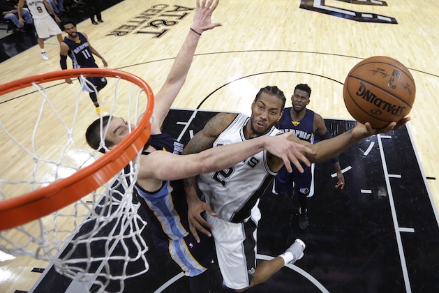 San Antonio Spurs forward Kawhi Leonard (2) drives to the basket against Memphis Grizzlies center Marc Gasol, left, during the second half of Game 5 in a first-round NBA basketball playoff series, Tuesday, April 25, 2017, in San Antonio. San Antonio won 116-103. (AP Photo/Eric Gay)