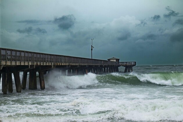 Waves pound the Pompano Beach Fishing Pier due to the inclement weather caused by Hurricane Matthew on October 6, 2016 in Pompano beach, Florida.
Residents of the US state of Florida scrambled to escape the path of Hurricane Matthews on Thursday as it pounded the Bahamas after leaving 27 people dead in the Caribbean.The storm, which is swirling near the northwest Bahamas, is expected to intensify to a Category Four hurricane as it moves northwest towards Florida.
 / AFP / Gaston De Cardenas        (Photo credit should read GASTON DE CARDENAS/AFP/Getty Images)