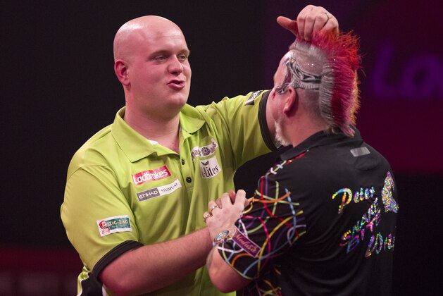 The Netherlands Michael van Gerwen runs his fingers through the hair of Britains Peter Wright after defeating Wright in the PDC World Championship darts final at Alexandra Palace in north London on January 1, 2014.   AFP PHOTO / Justin TALLIS        (Photo credit should read JUSTIN TALLIS/AFP/Getty Images)