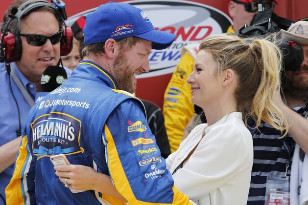Dale Earnhardt Jr. ,left, gets a hug from his fiancee Amy Reimann as he celebrates winning the Xfinity series auto race at Richmond International Raceway in Richmond, Va., Saturday, April 23, 2016. (AP Photo/Steve Helber)