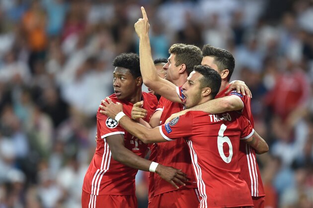 (L-R) Bayern Munich's Austrian defender David Alaba, Bayern Munich's Chilian midfielder Arturo Vidal, Bayern Munich's striker Thomas Mueller, Bayern Munich's Spanish midfielder Thiago Alcantara and Bayern Munich's Polish striker Robert Lewandowski celebrate an own goal by Madrid during the UEFA Champions League quarter-final second leg football match Real Madrid vs FC Bayern Munich at the Santiago Bernabeu stadium in Madrid in Madrid on April 18, 2017. / AFP PHOTO / Christof STACHE        (Photo credit should read CHRISTOF STACHE/AFP/Getty Images)