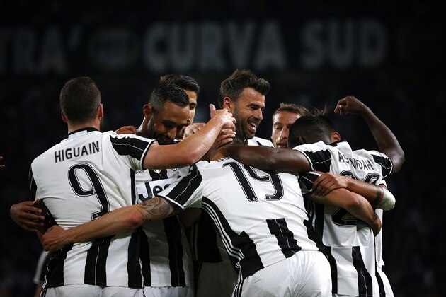 Juventus' defender Leonardo Bonucci (19) celebrates with teammates after scoring during the Italian Serie A football match Juventus Vs Genoa on April 23, 2017 at the 'Juventus Stadium' in Turin.  / AFP PHOTO / Marco BERTORELLO        (Photo credit should read MARCO BERTORELLO/AFP/Getty Images)