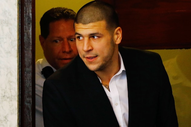 NORTH ATTLEBORO, MA - AUGUST 22: Aaron Hernandez is escorted into the courtroom of the Attleboro District Court for his hearing on August 22, 2013 in North Attleboro, Massachusetts. Former New England Patriot Aaron Hernandez has been indicted on a first-degree murder charge for the death of Odin Lloyd. (Photo by Jared Wickerham/Getty Images)