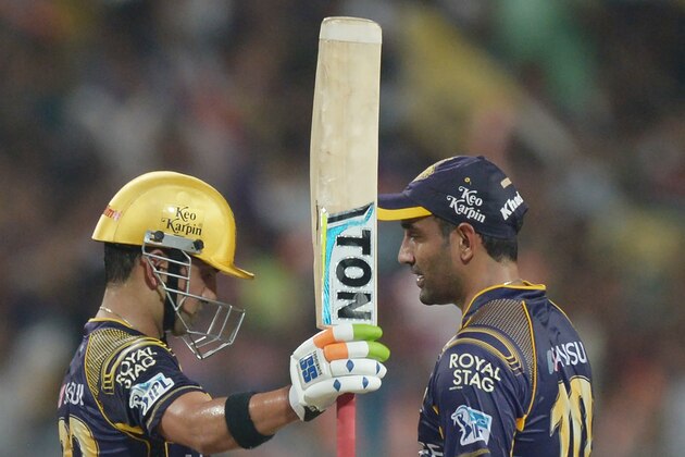 Kolkata Knight Riders captain Gautam Gambhir(L) celebrates after scoring a half-century (50 runs) as teammate Robin Uthappa looks on during the 2016 Indian Premier League(IPL) Twenty20 cricket match between Kolkata Knight Riders and Kings XI Punjab at The Eden Gardens Cricket Stadium in Kolkata on May 4, 2016.   / GETTYOUT / ----IMAGE RESTRICTED TO EDITORIAL USE - STRICTLY NO COMMERCIAL USE----- / GETTYOUT / AFP / Dibyangshu SARKAR        (Photo credit should read DIBYANGSHU SARKAR/AFP/Getty Images)