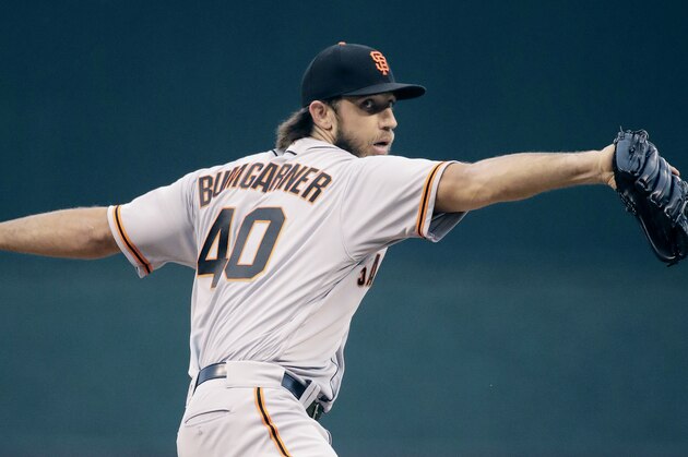 San Francisco Giants starting pitcher Madison Bumgarner throws during the first inning of the team's baseball game against the Kansas City Royals on Wednesday, April 19, 2017, in Kansas City, Mo. (AP Photo/Charlie Riedel)