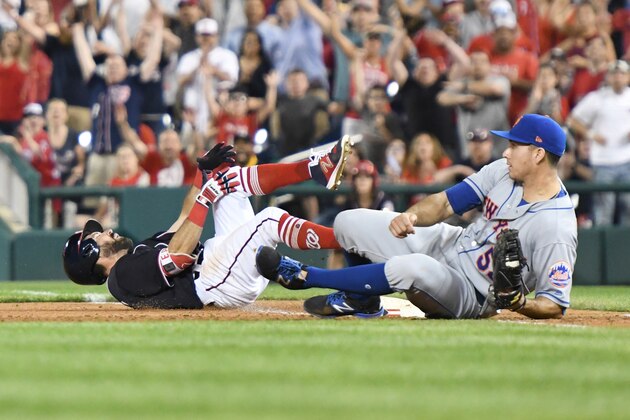 WASHINGTON, DC - APRIL 28:  Adam Eaton #2 of the Washington Nationals trips on base over T.J. Rivera #54 of the New York Mets in the ninth inning pitches during a baseball game at Nationals Park on April 28, 2017 in Washington, DC.  The Mets won 7-5.  (Photo by Mitchell Layton/Getty Images)