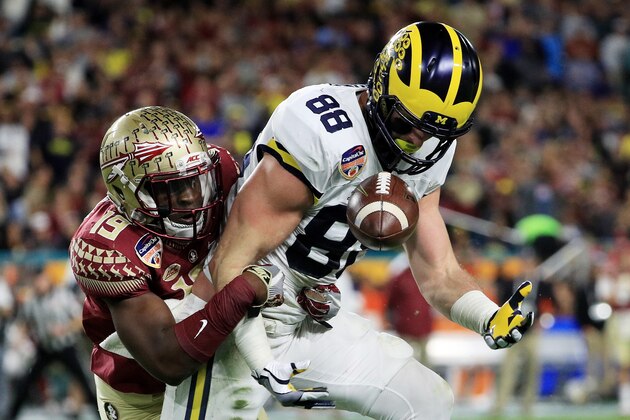 MIAMI GARDENS, FL - DECEMBER 30:  Jake Butt #88 of the Michigan Wolverines completes a pass against the defense of A.J. Westbrook #19 of the Florida State Seminoles in the first half during the Capitol One Orange Bowl at Sun Life Stadium on December 30, 2016 in Miami Gardens, Florida.  (Photo by Mike Ehrmann/Getty Images)