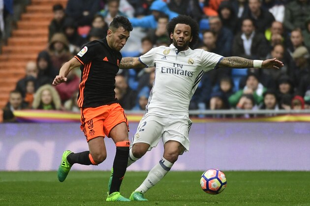 Real Madrid's Brazilian defender Marcelo (R) vies with Valencia's forward Munir El Haddadi during the Spanish league football match Real Madrid CF vs Valencia CF at the Santiago Bernabeu stadium in Madrid on April 29, 2017. / AFP PHOTO / PIERRE-PHILIPPE MARCOU        (Photo credit should read PIERRE-PHILIPPE MARCOU/AFP/Getty Images)
