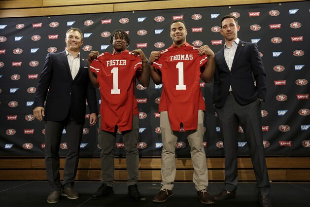From left to right, San Francisco 49ers general manager John Lynch poses for photos with draft picks Reuben Foster, Solomon Thomas and head coach Kyle Shanahan at a news conference in Santa Clara, Calif., Friday, April 28, 2017. (AP Photo/Jeff Chiu)