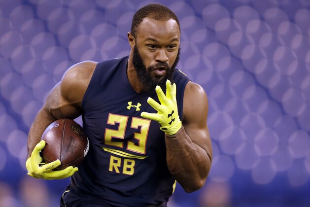 Oklahoma running back Samaje Perine runs a drill at the NFL football scouting combine in Indianapolis, Friday, March 3, 2017. (AP Photo/Michael Conroy)