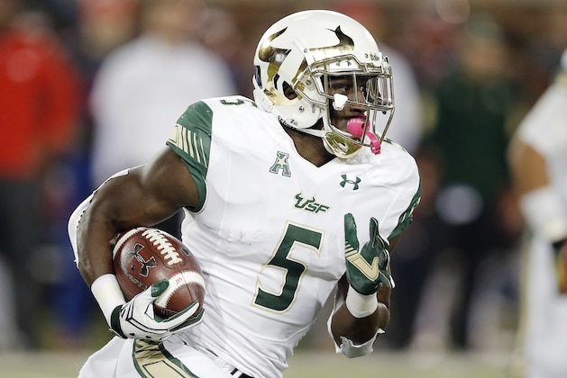 South Florida running back Marlon Mack (5) looks for room against the SMU defense during the first half of an NCAA college football game Saturday, Nov. 19, 2016, in Dallas. South Florida won 35-27. (AP Photo/Brandon Wade)