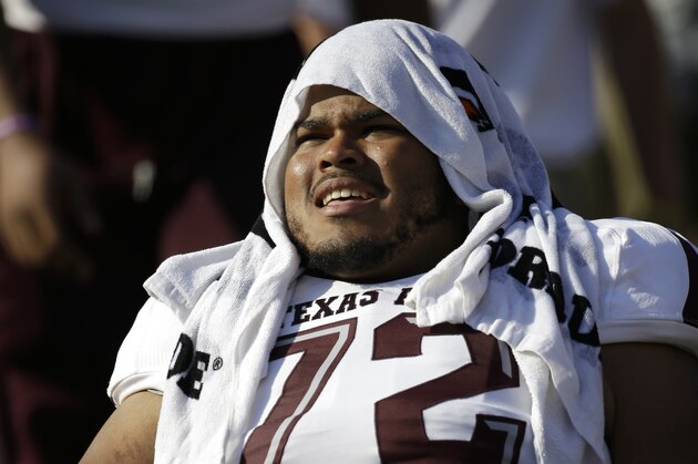 Texas A&M offensive linesman Jermaine Eluemunor (72) sits on the sideline during an NCAA college football game against SMU, Saturday, Sept. 20, 2014, in Dallas. (AP Photo/Tony Gutierrez)