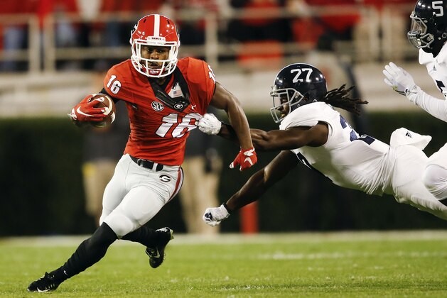Georgia wide receiver Isaiah McKenzie (16) tries to escape from Georgia Southern linebacker Ironhead Gallon (27) in the first half of an NCAA college football game Saturday, Nov. 21, 2015, in Athens, Ga. (AP Photo/John Bazemore)