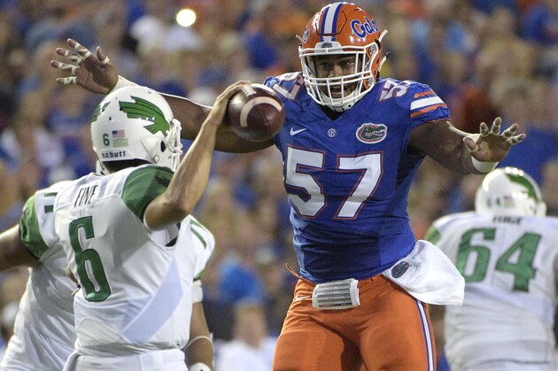 Florida defensive lineman Caleb Brantley (57) pressures North Texas quarterback Mason Fine (6) during the first half of an NCAA college football game in Gainesville, Fla., Saturday, Sept. 17, 2016. (AP Photo/Phelan M. Ebenhack)