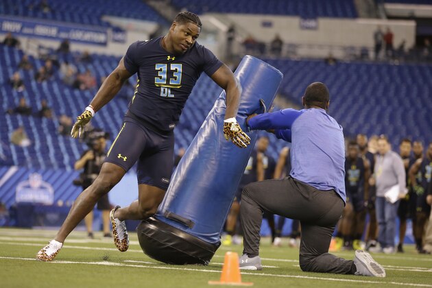 Miami defensive end Al-Quadin Muhammad runs a drill at the NFL football scouting combine in Indianapolis, Sunday, March 5, 2017. (AP Photo/Michael Conroy)