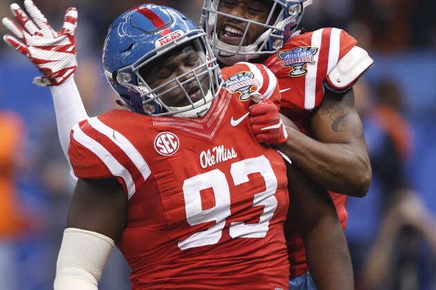 Mississippi defensive tackle D.J. Jones (93) celebrates his sack with linebacker C.J. Johnson in the first half of the Sugar Bowl college football game against Oklahoma State in New Orleans, Friday, Jan. 1, 2016. (AP Photo/Bill Feig)