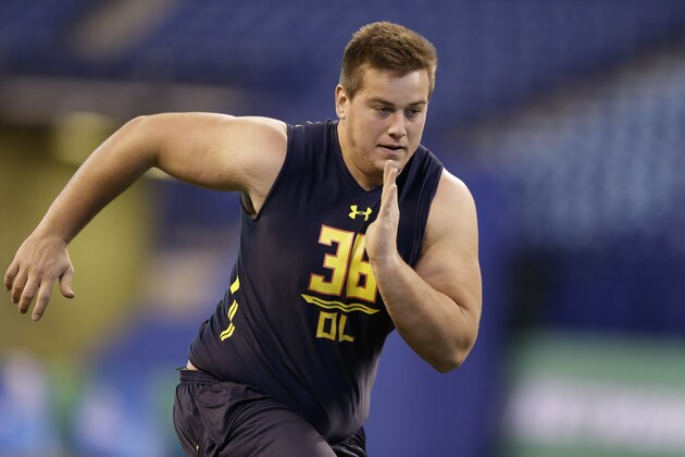 Wyoming offensive lineman Chase Roullier runs a drill at the NFL football scouting combine in Indianapolis, Friday, March 3, 2017. (AP Photo/Michael Conroy)