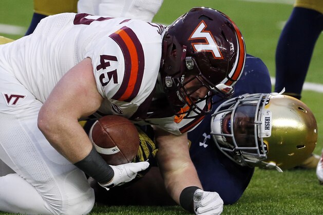 Virginia Tech fullback Sam Rogers, left, is tackled by Notre Dame defensive line Jarron Jones during the first half of an NCAA college football game in South Bend, Ind., Saturday, Nov. 19, 2016. (AP Photo/Nam Y. Huh)