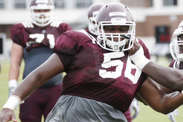 Mississippi State offensive linemen Justin Senior (58) and Jamaal Clayborn (60) joust with each other during drills at an NCAA college football practice in Starkville, Miss., Friday, Aug. 7, 2015. (AP Photo/Rogelio V. Solis)