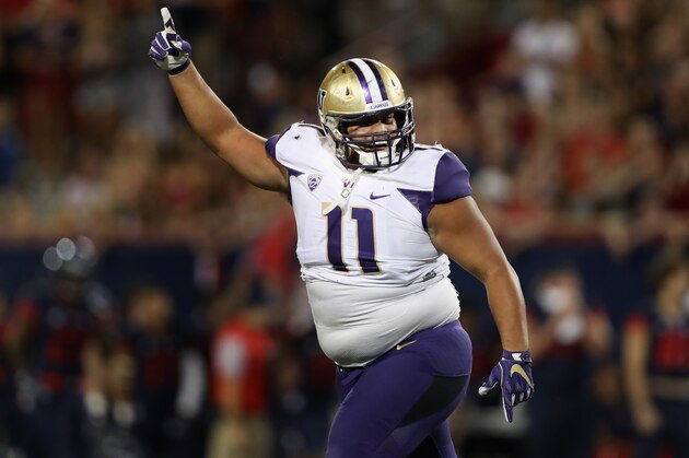 TUCSON, AZ - SEPTEMBER 24:  Defensive lineman Elijah Qualls #11 of the Washington Huskies celebrates after a defensive stop against the Arizona Wildcats during the fourth quarter of the college football game at Arizona Stadium on September 24, 2016 in Tucson, Arizona. The Huskies defeated the Wildcats 35-28.  (Photo by Christian Petersen/Getty Images)