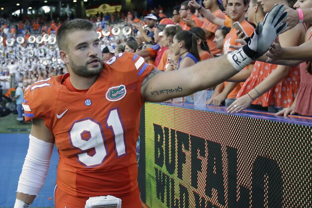 Florida defensive lineman Joey Ivie (91) high fives fans after defeating Kentucky 45-7 in an NCAA college football game, Saturday, Sept. 10, 2016, in Gainesville, Fla. (AP Photo/John Raoux)