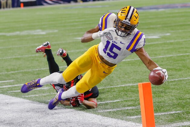 LSU wide receiver Malachi Dupre (15) dives for the goal line but is pushed out of bounds by Texas Tech defensive back Justis Nelson (31) during the second half of the Texas Bowl NCAA football game Tuesday, Dec. 29, 2015, in Houston. LSU won 56-27. (AP Photo/Bob Levey)