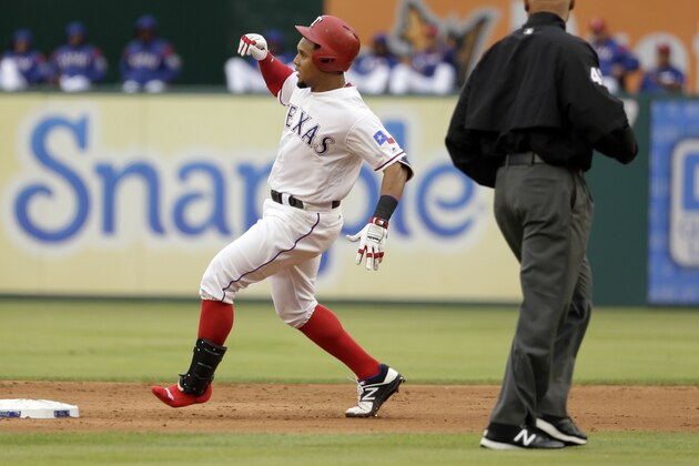 Second base umpire Kerwin Danley watches as Texas Rangers' Carlos Gomez, missing a shoe, arrives at second with a double during the first inning of the team's baseball game against the Los Angeles Angels in Arlington, Texas, Saturday, April 29, 2017. Gomez lost his left shoe going around first base on the hit. (AP Photo/Tony Gutierrez)