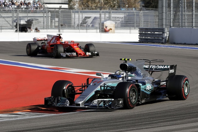 Mercedes driver Valtteri Bottas of Finland takes a curve followed by Ferrari driver Sebastian Vettel of Germany during the Formula One Russian Grand Prix at the 'Sochi Autodrom' circuit, in Sochi, Russia, Sunday, April. 30, 2017. (AP Photo/Sergei Grits)