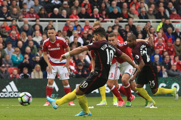 Manchester City's Argentinian striker Sergio Aguero (C) scores the one-all equaliser goal from a penalty during the English Premier League football match between Middlesbrough and Manchester City at Riverside Stadium in Middlesbrough, northeast England on April 30, 2017. / AFP PHOTO / Lindsey PARNABY / RESTRICTED TO EDITORIAL USE. No use with unauthorized audio, video, data, fixture lists, club/league logos or 'live' services. Online in-match use limited to 75 images, no video emulation. No use in betting, games or single club/league/player publications.  /         (Photo credit should read LINDSEY PARNABY/AFP/Getty Images)