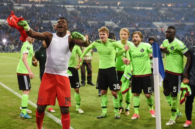 Ajax Amsterdam's players celebrate after the UEFA Europa League 2nd-leg quarter-final football match between Schalke 04 and Ajax Amsterdam in Gelsenkirchen, western Germany on April 20, 2017. / AFP PHOTO / PATRIK STOLLARZ        (Photo credit should read PATRIK STOLLARZ/AFP/Getty Images)