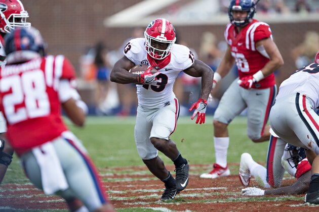 OXFORD, MS - SEPTEMBER 24:  Elijah Holyfield #13 of the Georgia Bulldogs rushes the ball during a game against the Mississippi Rebels at Vaught-Hemingway Stadium on September 24, 2016 in Oxford, Mississippi.  The Rebels defeated the Bulldogs 45-14.  (Photo by Wesley Hitt/Getty Images)