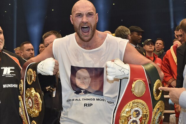 FILE - In this Nov. 29, 2015 file photo, Britain's new world champion Tyson Fury, celebrates with the WBA, IBF, WBO and IBO belts after winning the world heavyweight title fight against Ukraine's Wladimir Klitschko in Duesseldorf, western Germany. Tyson Fury's boxing career could be over after the reigning IBF, WBO and WBA heavyweight champion announced his retirement in a profanity-filled tweet on Monday Oct. 3, 2016. (AP Photo/Martin Meissner, File)