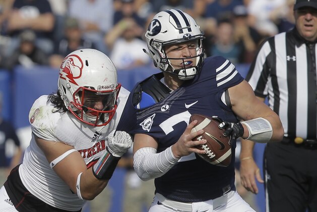 BYU quarterback Taysom Hill (7) eludes Southern Utah defensive lineman Taylor Pili (8) tackle in the first quarter during an NCAA college football game Saturday, Nov. 12, 2016, in Provo, Utah. (AP Photo/Rick Bowmer)