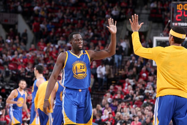 PORTLAND, OR - APRIL 24:  Draymond Green #23 of the Golden State Warriors high fives his teammate during the game against the Portland Trail Blazers during Game Four of the Western Conference Quarterfinals of the 2017 NBA Playoffs on April 24, 2017 at the Moda Center in Portland, Oregon. NOTE TO USER: User expressly acknowledges and agrees that, by downloading and or using this Photograph, user is consenting to the terms and conditions of the Getty Images License Agreement. Mandatory Copyright Notice: Copyright 2017 NBAE (Photo by Sam Forencich/NBAE via Getty Images)