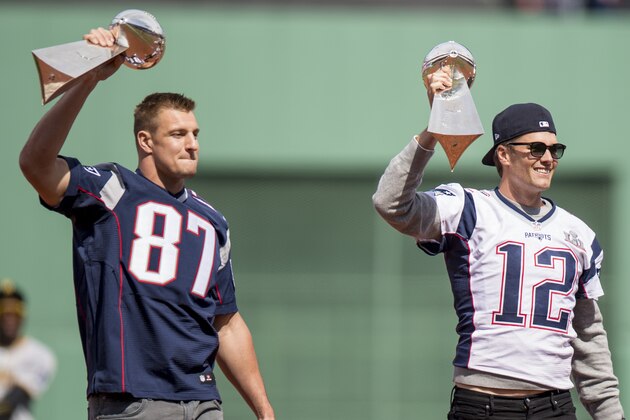 BOSTON, MA - APRIL 3: Tom Brady #12 and Rob Gronkowski #87 of the New England Patriots hold the Super Bowl trophies during a pre-game ceremony before the Boston Red Sox home opener against the Pittsburgh Pirates on April 3, 2017 at Fenway Park in Boston, Massachusetts. (Photo by Billie Weiss/Boston Red Sox/Getty Images)